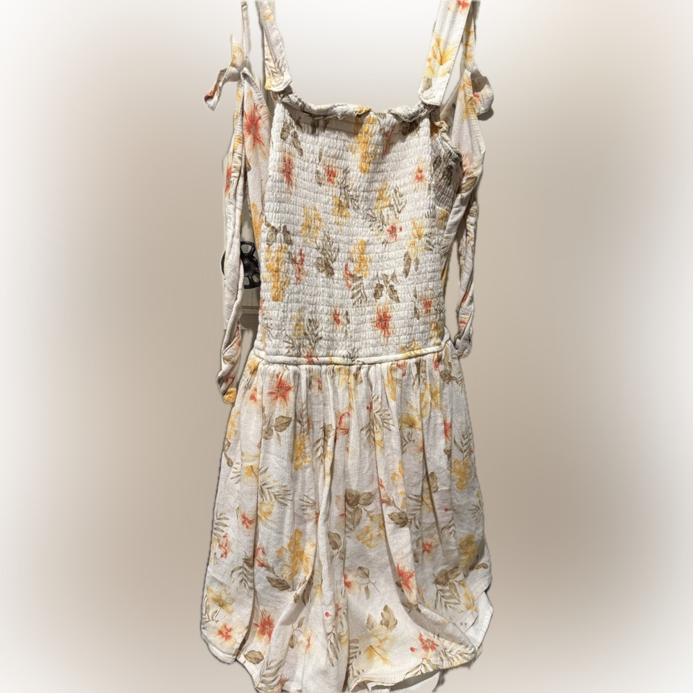 Stylish floral romper with tie back.